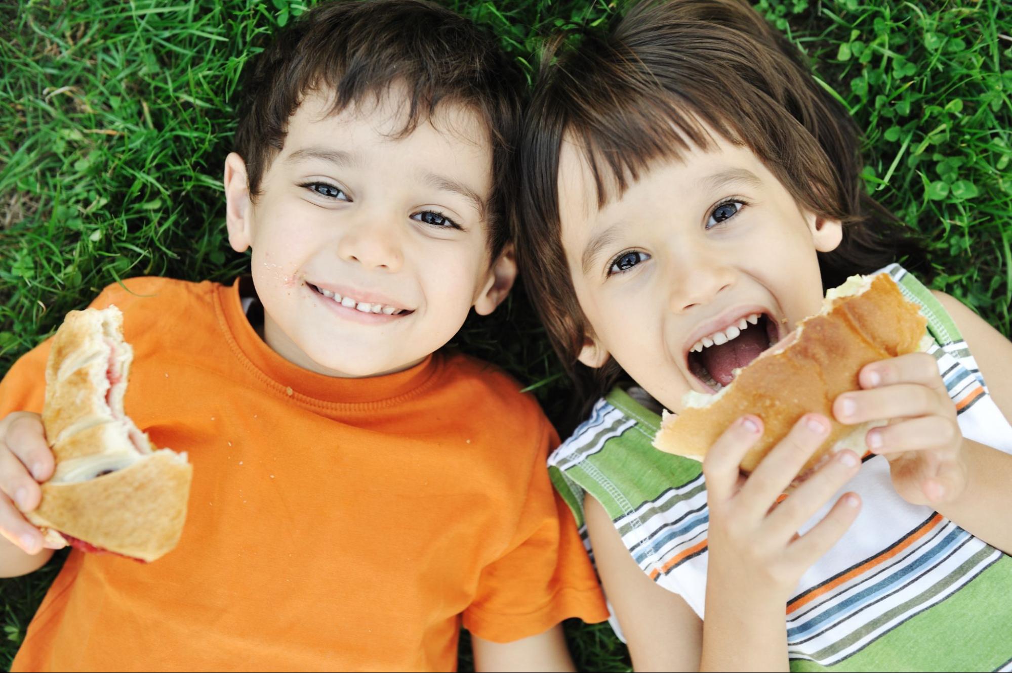 Two Kids Enjoying a Sandwich on the Ground ©ESB Professional